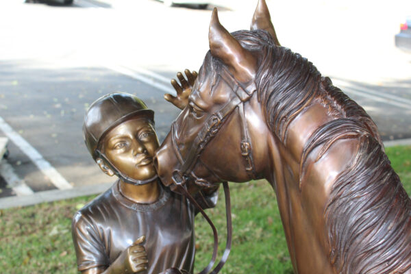 bronze statue of a girl and horse