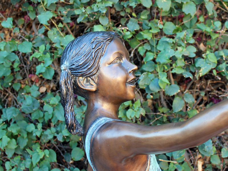 bronze statue of girl holding shell