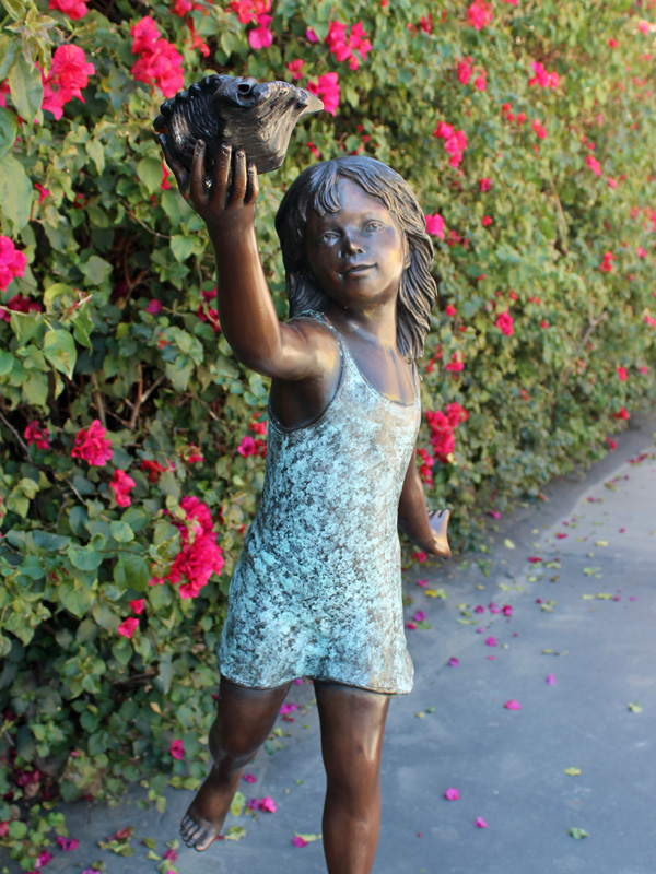 bronze statue of a girl standing on a turtle