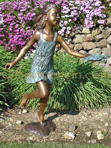 bronze statue of a girl with turtle