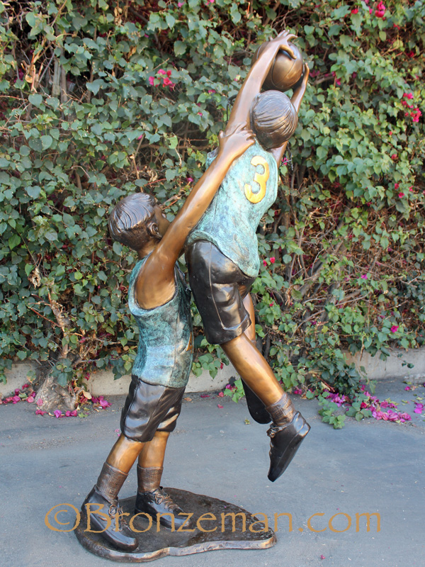 bronze sculpture of children playing basketball