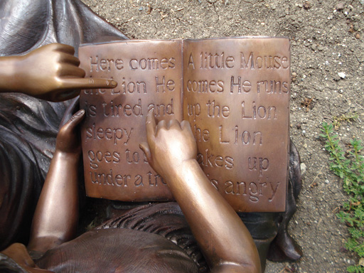 bronze statue of children reading
