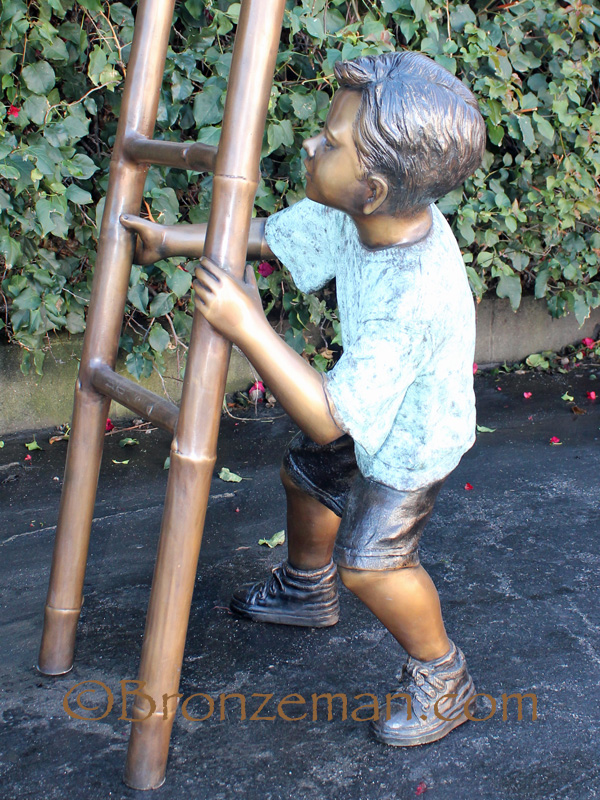 bronze statue of children on a ladder