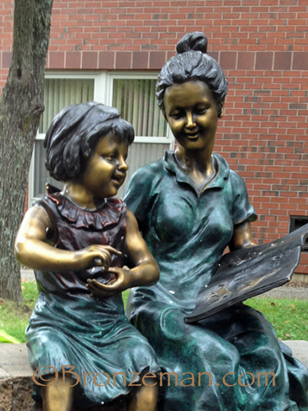 bronze statue of a teacher and child