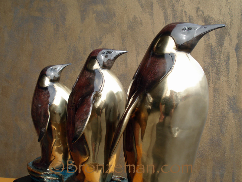 bronze statue of three penguins
