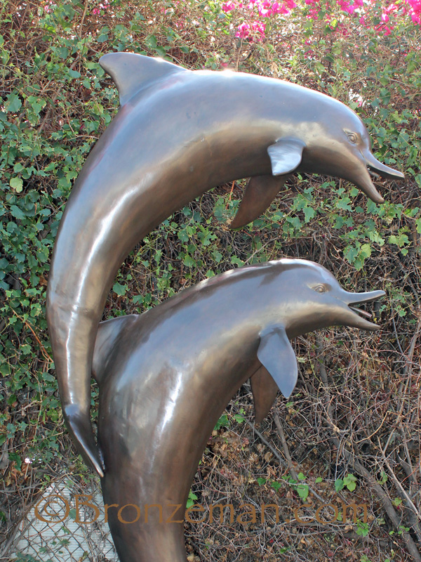 bronze statue of two dolphins