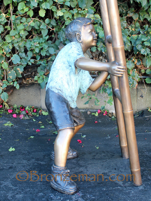 bronze statue of children on a ladder