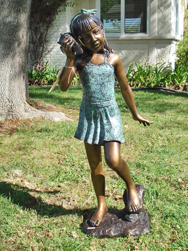 bronze sculpture of a girl holding a shell