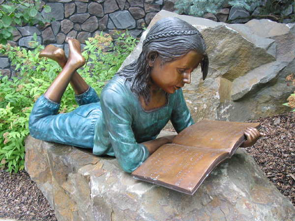 bronze statue of girl reading