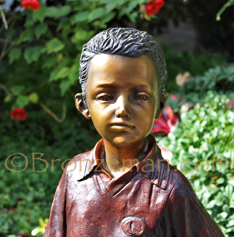 bronze statue of a boy soccer player