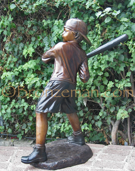 bronze statue of a boy playing baseball
