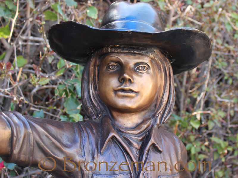 bronze statue of a cowgirl with horse