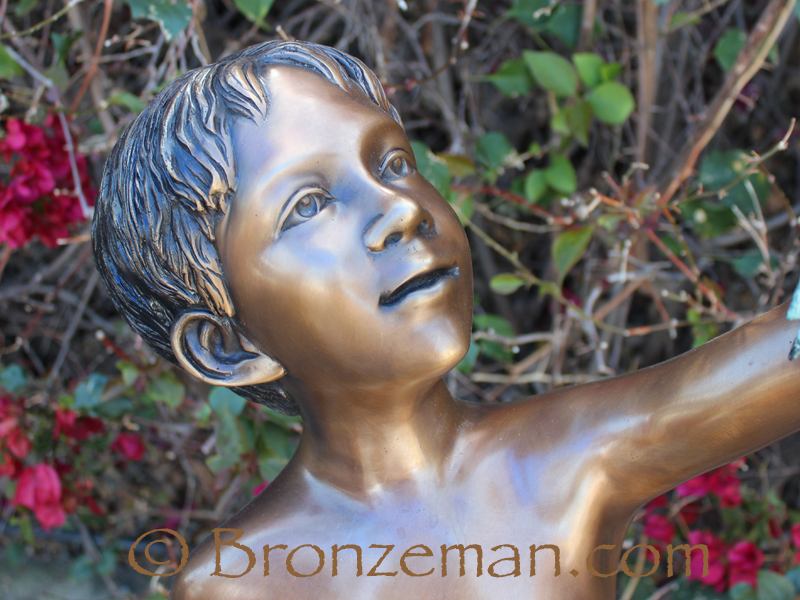 bronze boy with frogs