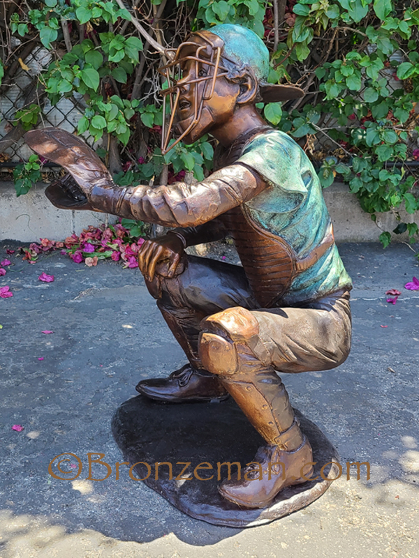 bronze statue of boy catching a baseball