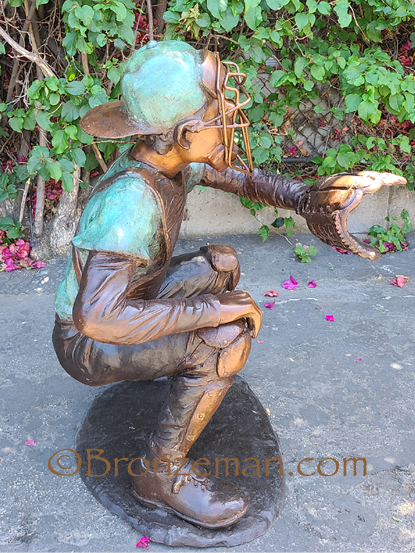 bronze statue of boy catching a baseball