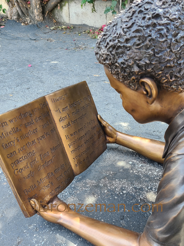 bronze boy reading