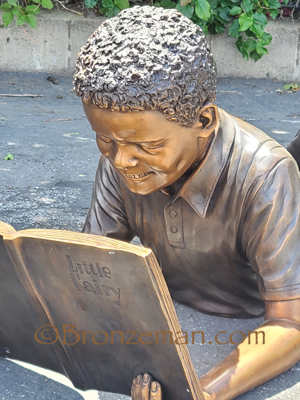 bronze boy reading