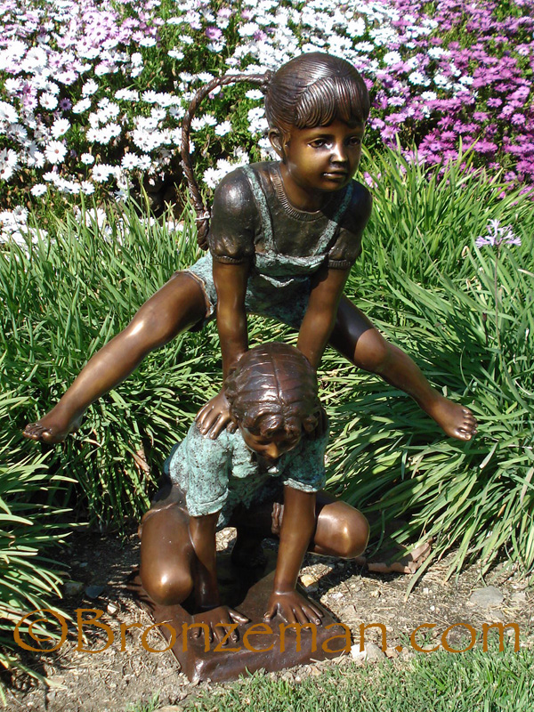 bronze statue of children playing leap frog