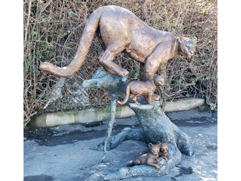 bronze statue of a mountain lion and cubs